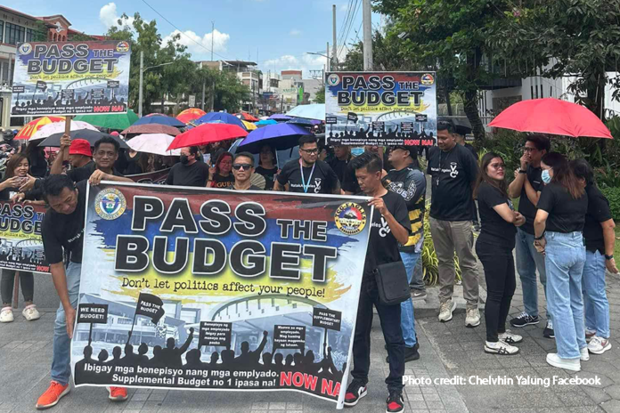 Scores of black-clad participants join the protest march against the Tarlac City Council's delay in the approval of the supplemental budget.